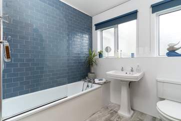 The family bathroom on the ground floor has a bath and overhead shower.