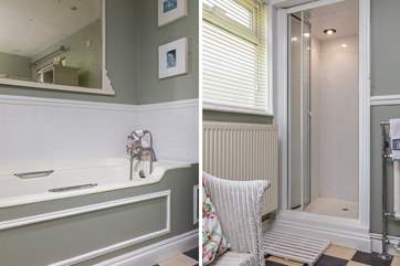 There is a big tub and a shower in the family bathroom.
