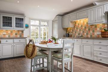 The lovely kitchen for all your culinary needs has a causal breakfast table for more informal dining.