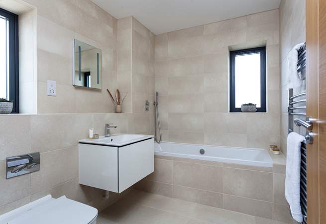 The lovely contemporary family bathroom is also located on the first floor.