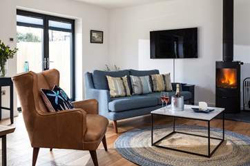 In the sitting-area you have plenty of space to sprawl out, or if you prefer cosy up in front of the roaring wood-burner.