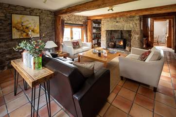 The fabulous sitting-room with glowing wood-burning stove. Perfect for snuggling up in after a full day of exploring.