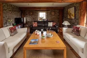 The sitting-room offers oodles of comfy seating and a generous sized coffee table.