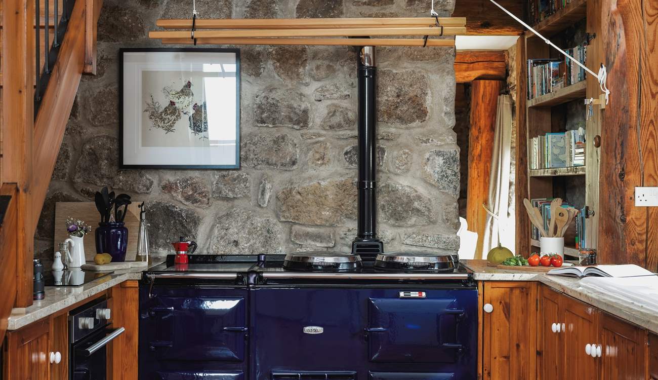 The spacious and well-equipped kitchen. The Aga is ornamental but you do have an induction hob and electric oven for cooking up your holiday meals.