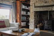 The sitting-room offers oodles of comfy seating and a generous sized coffee table.