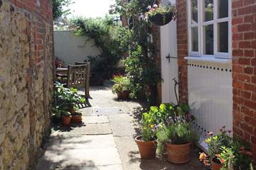 The beautifully presented patio garden has a feel of the Mediterranean.