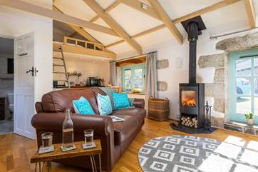 The living space is light and airy but super cosy in front of the wood-burner.