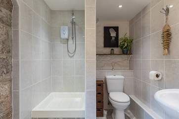 The shower-room is set up in a wet-room style.