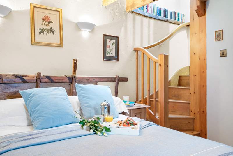 The beautiful bedroom is linked to the first floor living quarters via this spiral staircase.