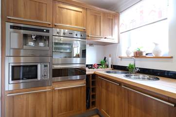 This stylish kitchen has all the mod-cons including a coffee machine for your morning espresso.