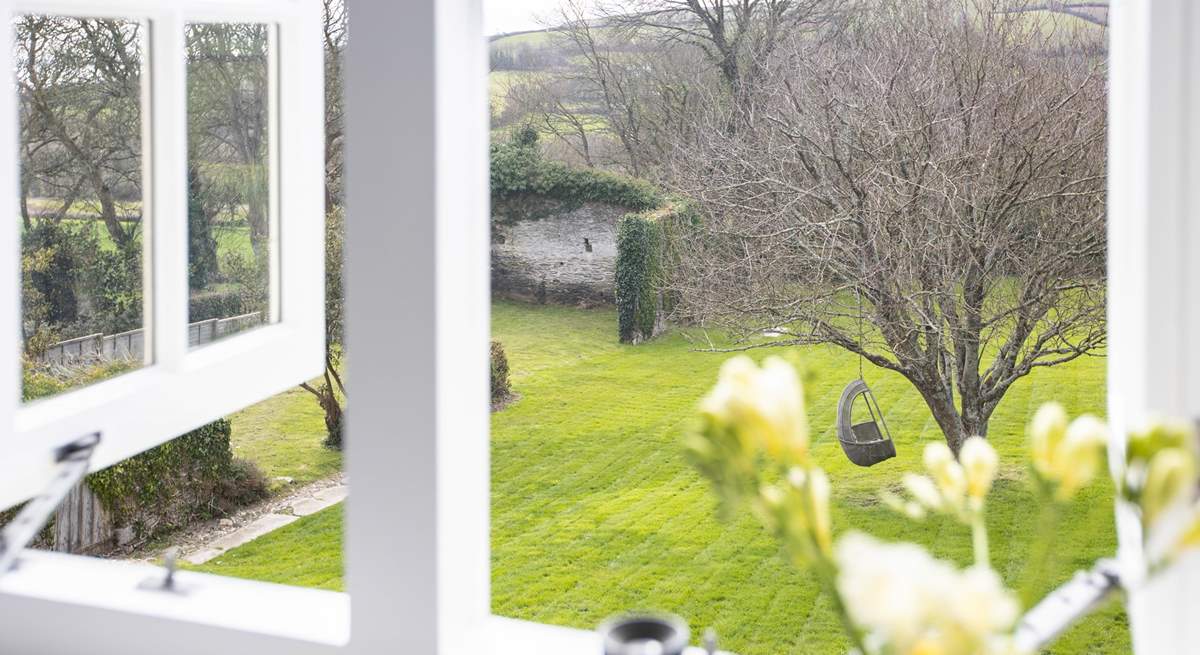 Bedroom 4 and the stunning view out over the lawn and the rolling countryside and hills of the South Hams.