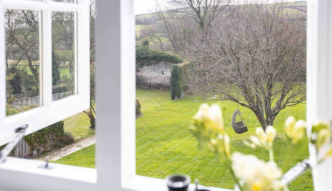 Bedroom 4 and the stunning view out over the lawn and the rolling countryside and hills of the South Hams.
