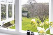 Bedroom 4 and the stunning view out over the lawn and the rolling countryside and hills of the South Hams.