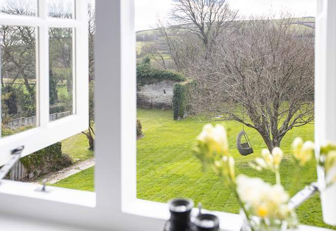 Bedroom 4 and the stunning view out over the lawn and the rolling countryside and hills of the South Hams.