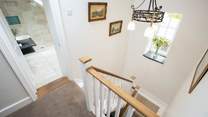 These beautiful stairs and a rather grand landing area link the ground floor and first floor.