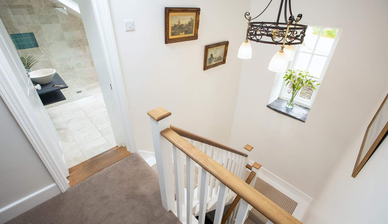 These beautiful stairs and a rather grand landing area link the ground floor and first floor.