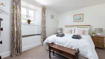 Bedroom 2 is light, airy, and super welcoming.