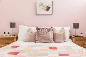 The pretty pink bedroom is located on the first floor.