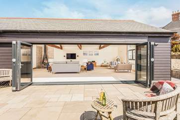 Open wide the bi-fold doors leading out onto the terrace.