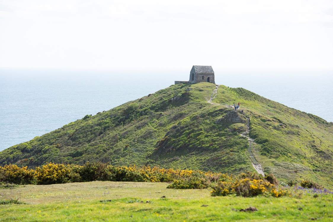 Take the footpath that leads out to the tiny chapel on the headland.