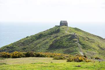 Take the footpath that leads out to the tiny chapel on the headland.