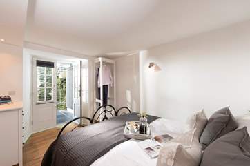Patio doors lead out from the bedroom to a lower terrace.
