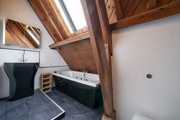 The family bathroom on the first floor with a jet feature designed for relaxation whilst bathing! Please note there is a slight head restriction above the bath.
