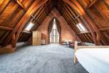 The impressive sixth bedroom with fine exposed beams and an incredible amount of space.