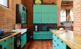 The modern style kitchen adapts well with the historic building.  - Thumbnail Image