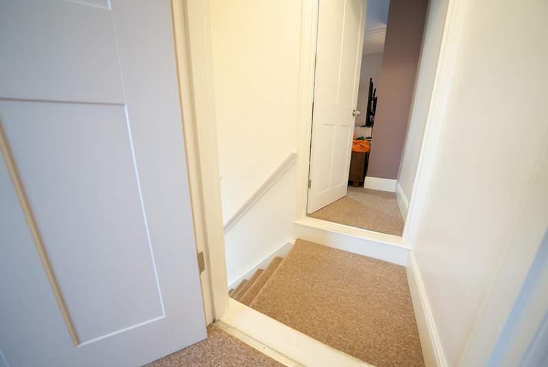At the top of the stairs step into the bedroom at the front of the house or the living room to the rear.