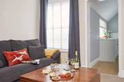 There is lots of natural light coming through the windows in the sitting/dining-room and kitchen.