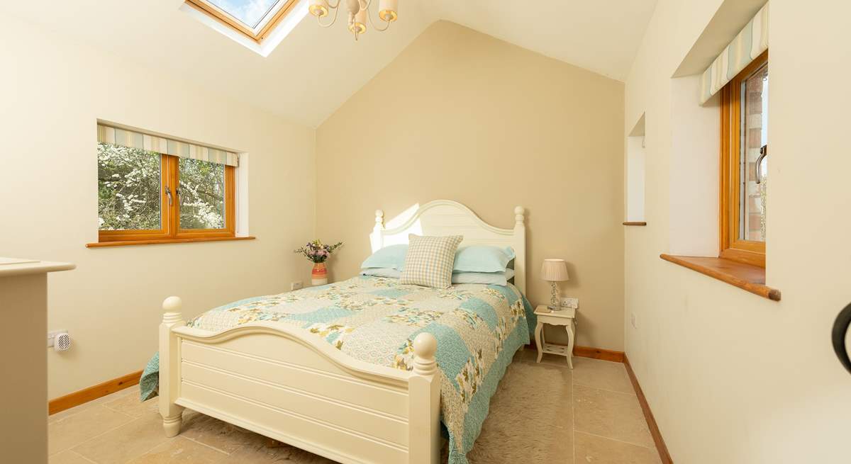 The gorgeous bedroom with light flooding in.