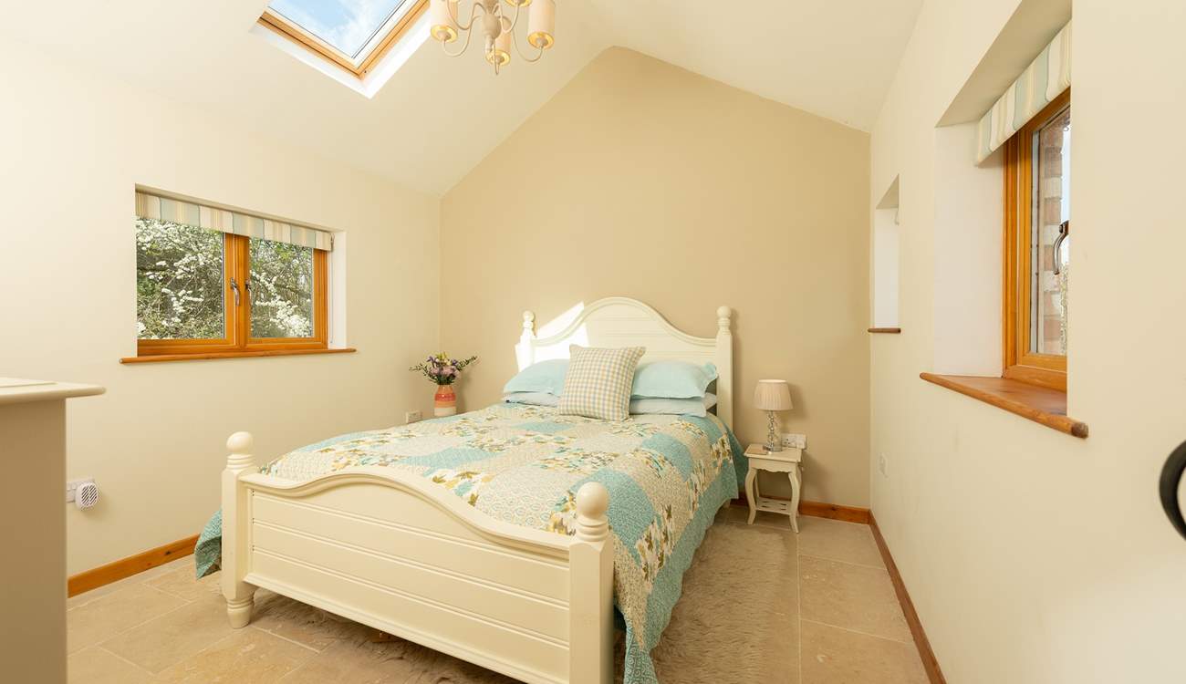 The gorgeous bedroom with light flooding in.