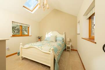 The gorgeous bedroom with light flooding in.