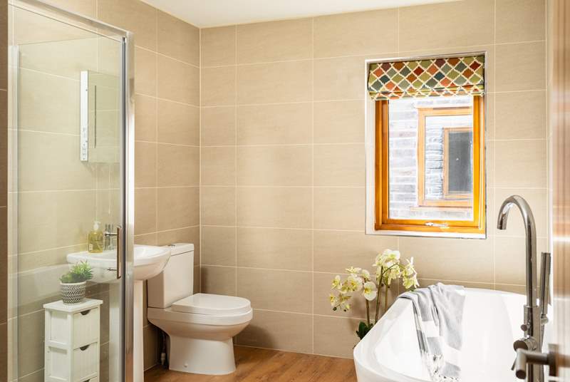 The family bathroom has a large shower and lovely free-standing bath.