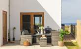 The patio area is perfect for a barbecue or a relaxed glass of wine in the sunshine. - Thumbnail Image