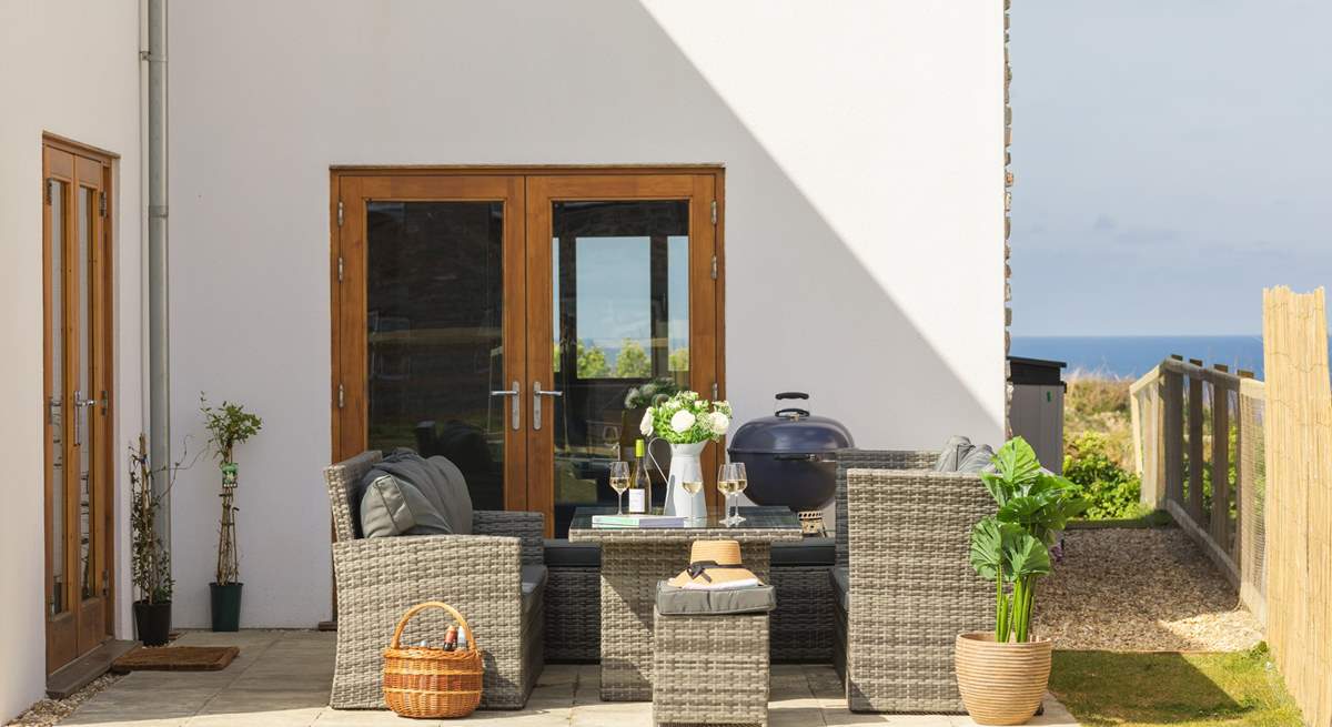 The patio area is perfect for a barbecue or a relaxed glass of wine in the sunshine.