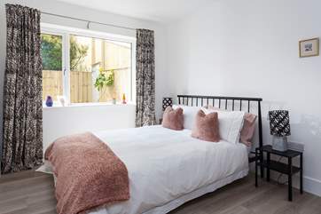 The pink bedroom overlooks the rear terrace.