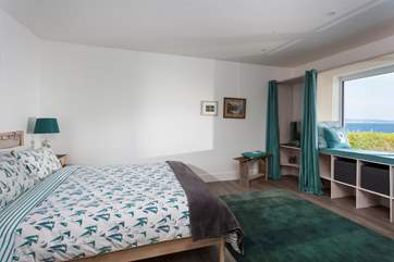The main bedroom on the ground floor, has an en suite shower-room, and views of Mount's Bay.