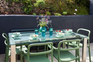 At the rear of the property there is another terrace with a table and chairs for informal meals,