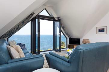 Upstairs the sitting area has two comfy sofas each with extensive sea views.