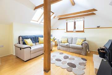 The main sitting-room on the first floor offers the perfect place to sit back, light the log-burner and catch up on those missed films.