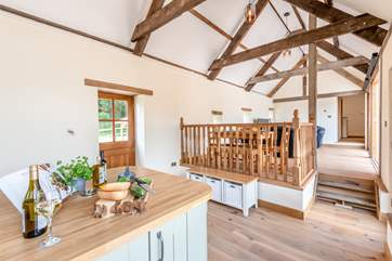 With double height ceiling and re-claimed oak beams, the light and airy open plan living space is a delight.