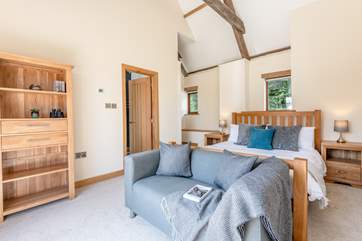 Fabulous bedroom 1 has luxury bedding and a sofa for a quiet holiday read.