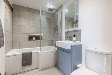 The family bathroom has a drench shower over the bath.