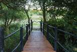 Head across the bridge through the gate and down to the lake from your secluded garden.