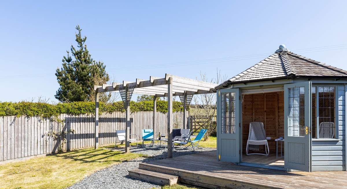 A summer-house awaits in the lovely garden.