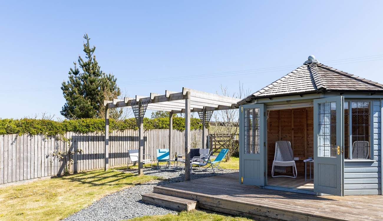 A summer-house awaits in the lovely garden.