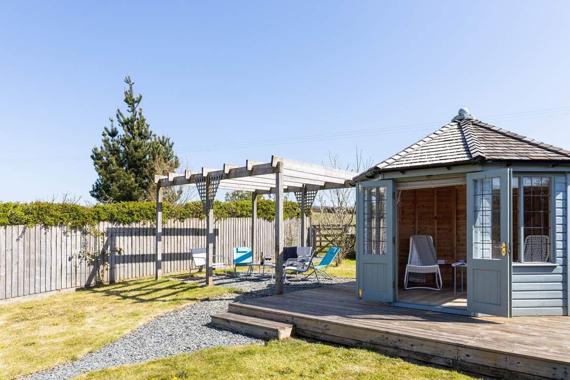 A summer-house awaits in the lovely garden.