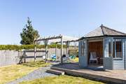 A summer-house awaits in the lovely garden.